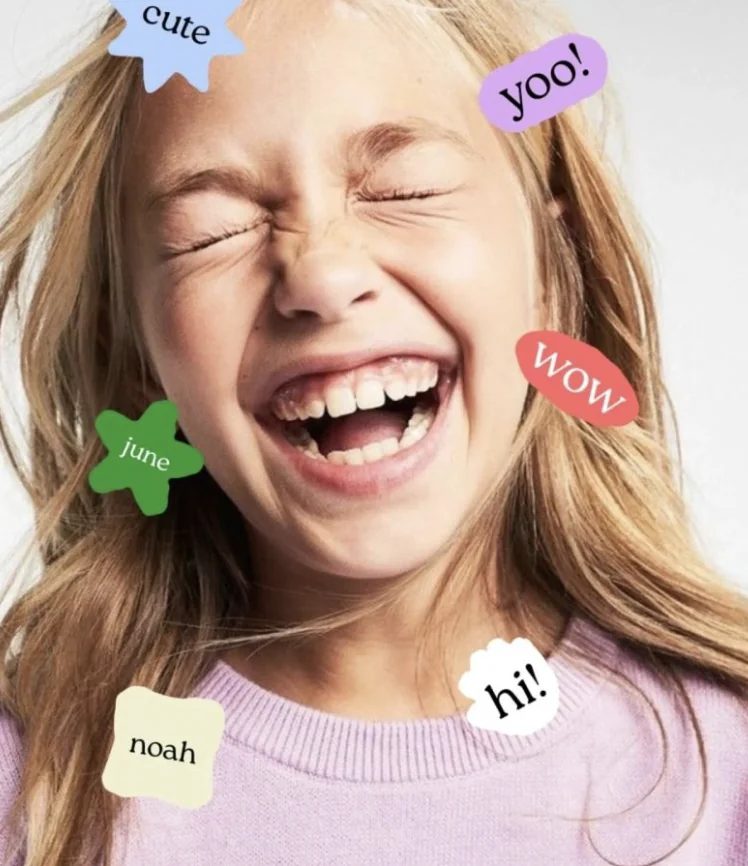 A laughing kid with playful name stickers